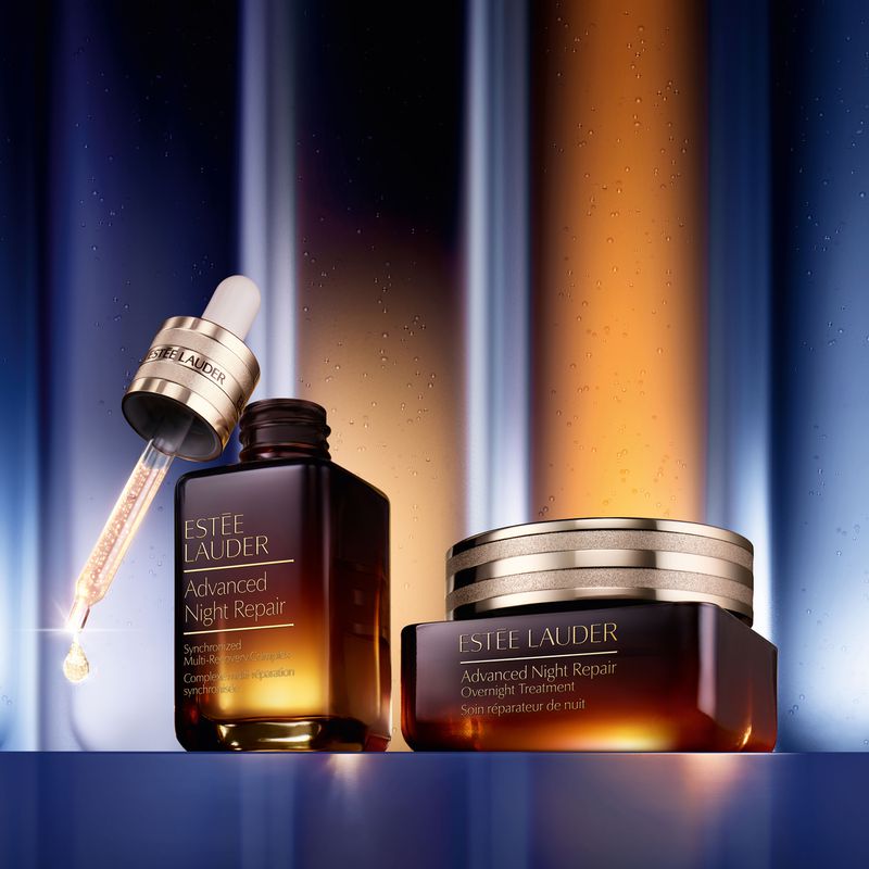 Estee Lauder Advanced Night Repair products are displayed in a product shot with an eye dropper, serum bottle, and cream in a jar.