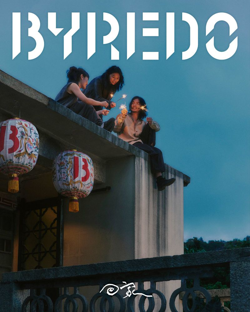 Three people sit on a rooftop at night, holding sparklers; two hanging lanterns, and the BYREDO logo are also visible.