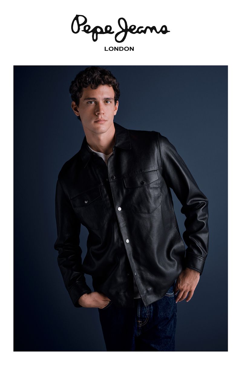 A young adult male poses in a black leather jacket and jeans against a dark blue background, highlighted by the 'Pepe Jeans London' logo.