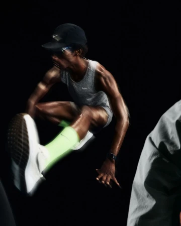A dynamic action shot shows an athlete mid-air, leaping in sportswear against a dark background, emphasizing motion in sports and fitness.