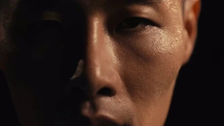Close-up macro portrait of a sweating man face in low-key lighting for Nike Stride and Swift