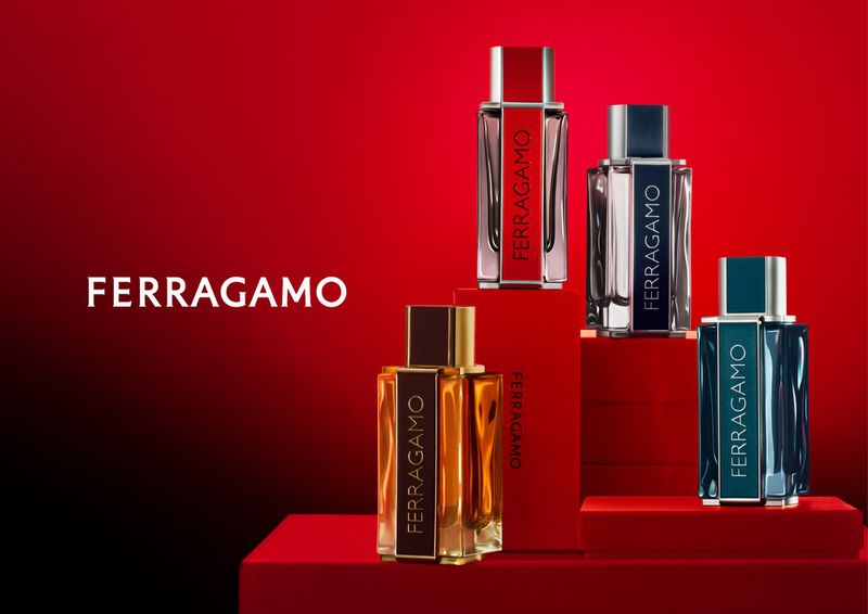 Four Ferragamo perfume bottles in varying colors sit on red platforms against a gradient red-to-black background, showcasing fragrance products.