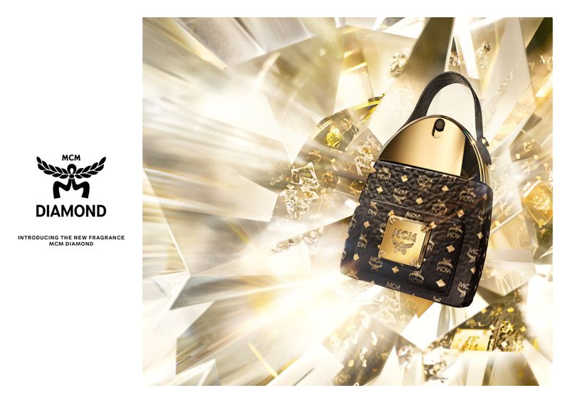 A patterned MCM handbag with gold accents, displayed against a bright, multi-faceted background for luxury fashion promotion.