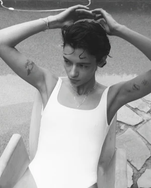 Model Anna Lee wearing minimalist jewellery and a white top with arms raised, photographed in black and white by Tim Ashton for Sarah & Sebastian.