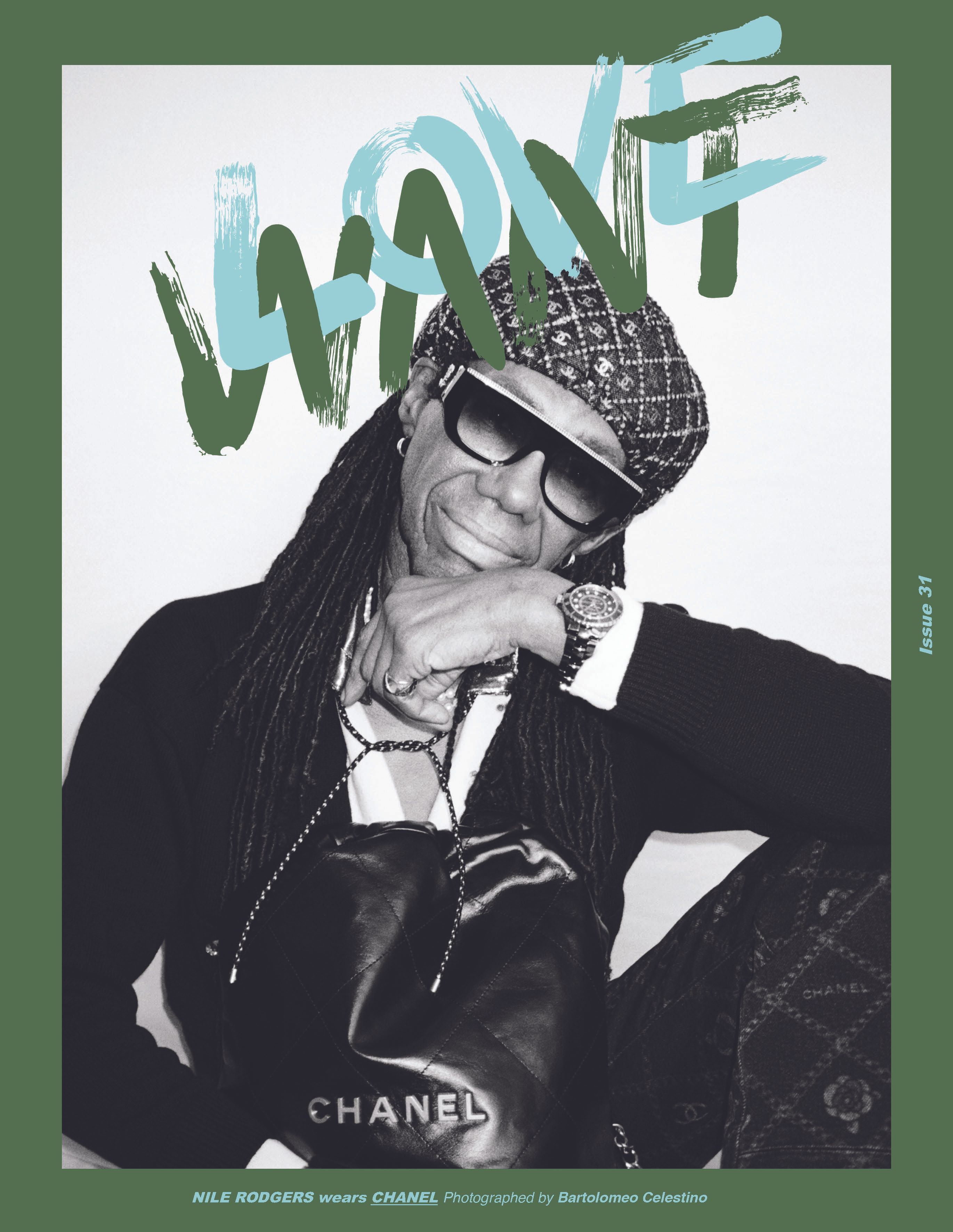 Black and white magazine cover featuring Nile Rodgers wearing sunglasses and hat with Chanel purse, and blue and green font.