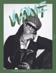 Nile Rodgers wearing sunglasses and patterned beret holding a black leather bag for Love Want Issue 31