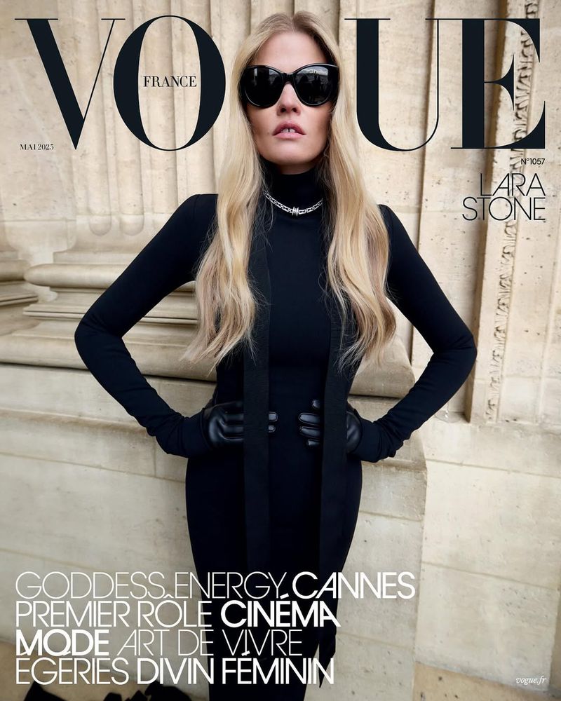 Vogue France cover featuring Lara Stone in a black turtleneck dress, sunglasses, and a necklace, posing against an architectural background.