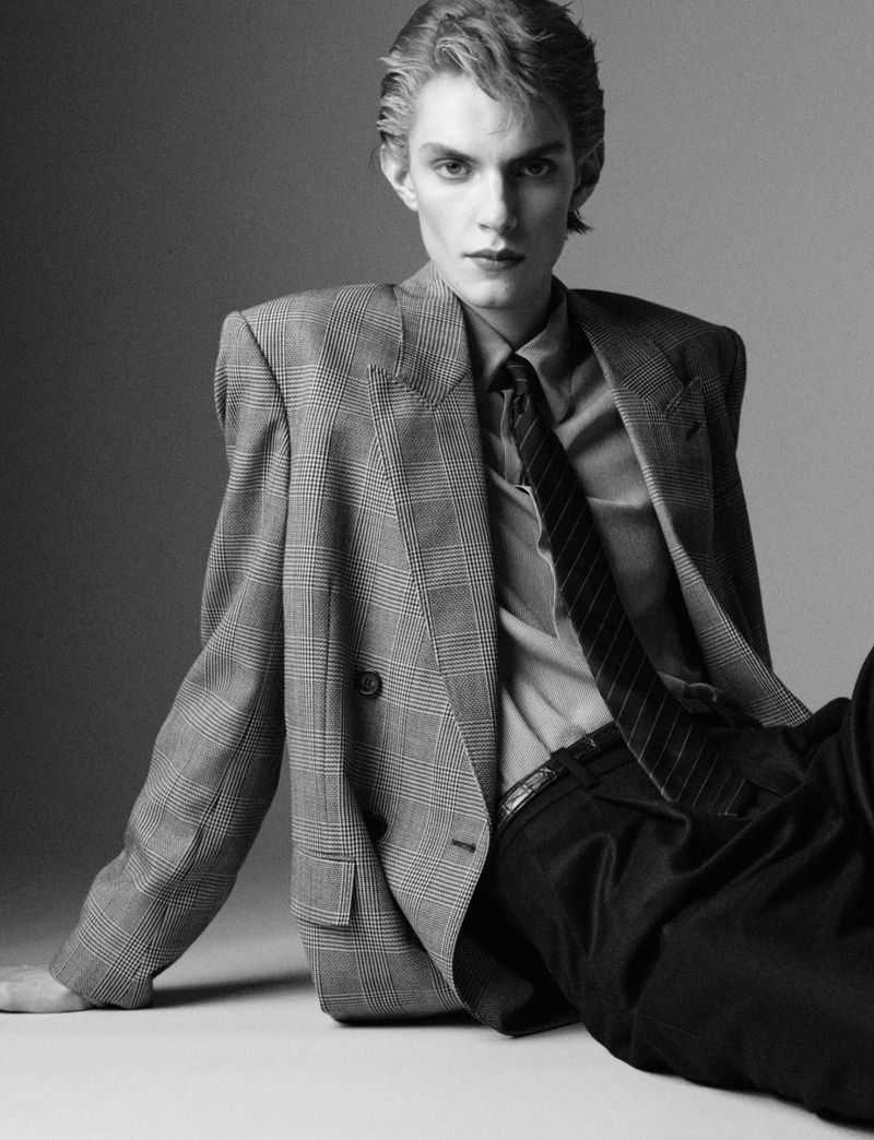 Model Alvar af Schulten wearing a plaid double-breasted blazer and tie in a black-and-white fashion portrait for Dapper Dan Magazine.