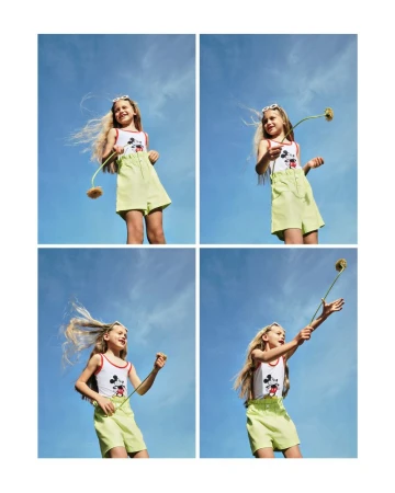 Young girl in shorts and a cartoon top holds a flower in four combined frames against a sunny blue sky, creating a playful outdoor composition.