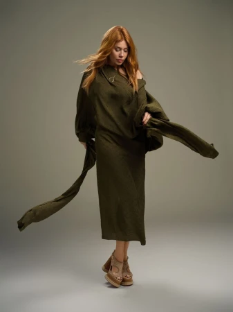 Palina Rojinski in an olive green dress and platform heels against a grey studio backdrop for L'Officiel Austria