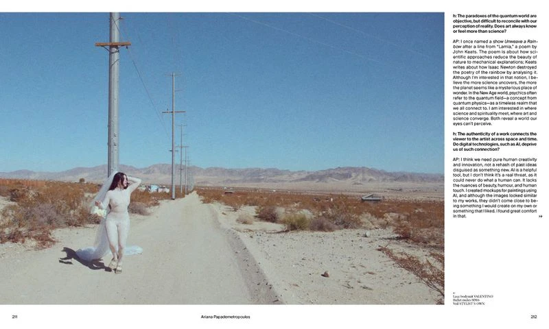 Fashion shot of a woman in a white dress and veil, standing on a desert road with telephone poles and mountains in the background on a sunny day.