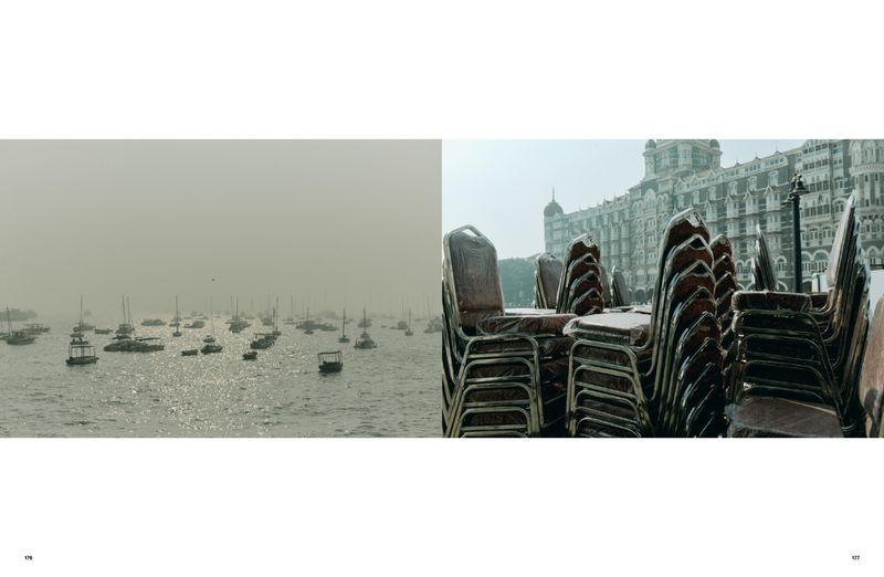 View of boats on water with the Taj Mahal Palace hotel in the background; many stacked chairs in the foreground.