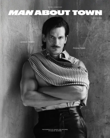 Man About Town magazine cover featuring a muscular man with mustache in shirt, leather pants and striped shirt draped on shoulder.