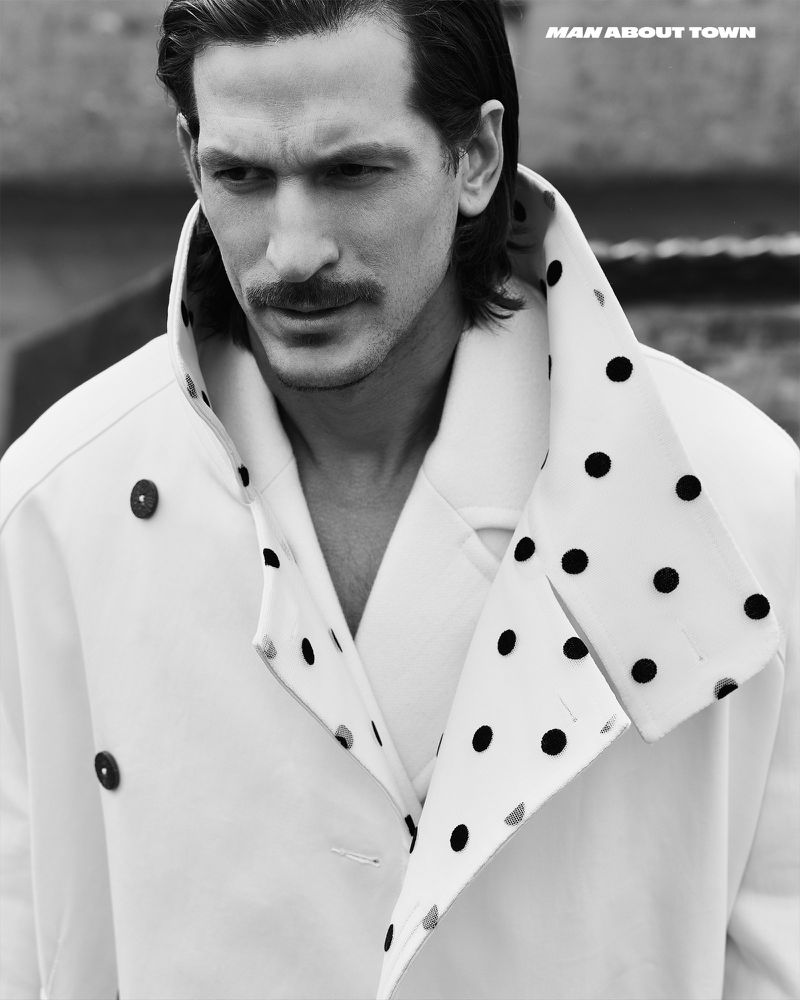 Close-up portrait of Jarrod Scott wearing a white coat with black polka dots for Man About Town magazine.