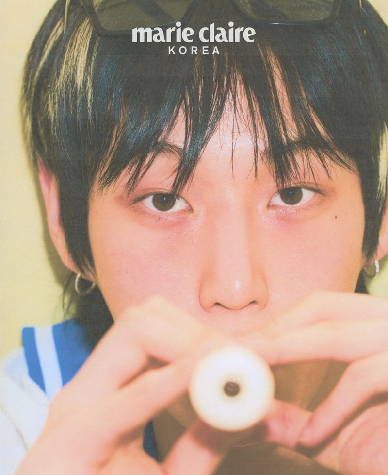Close-up of a young adult with dark hair and sunglasses on their head, holding a flute, with the 'Marie Claire Korea' logo in the corner.
