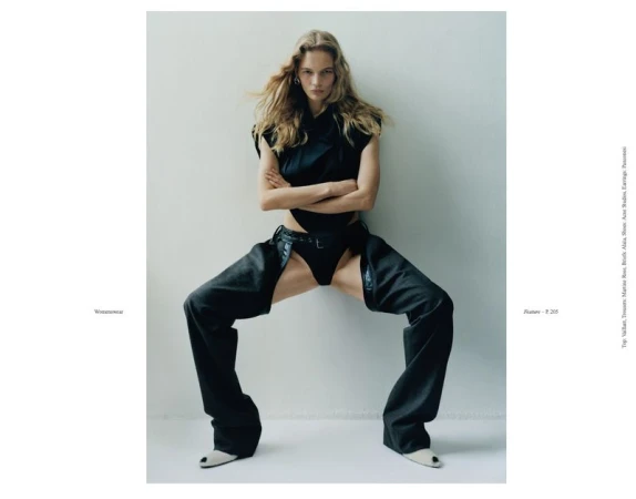 Model Caitlin Soetendal posing in dark clothing against a light grey studio background for Present Space project Double Dutch.