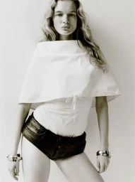 Model Caitlin Soetendal wearing a white top and dark shorts against a seamless white background for Present Space Double Dutch.