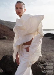 Model Litza Veloz wearing a sculptural white top and white trousers outdoors for Damernas Varld Top Shape project.