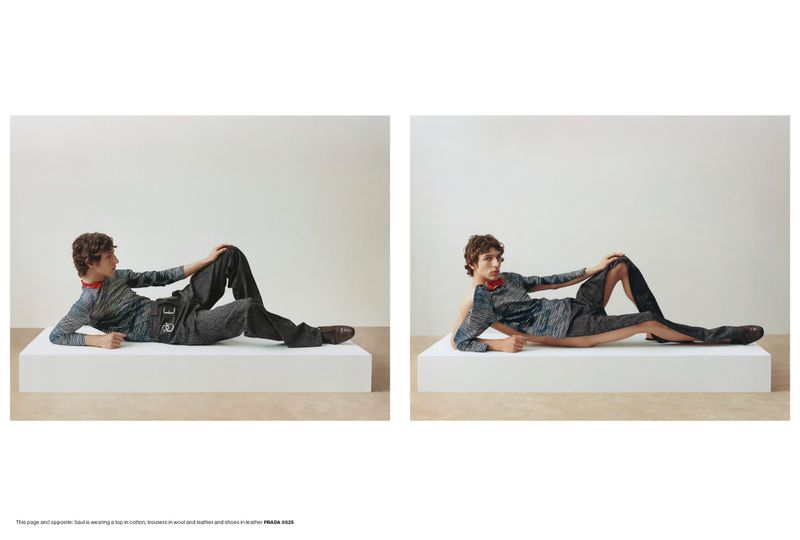 A fashion shot shows a model lying on a white block wearing a grey patterned long-sleeved shirt, grey pants, and brown leather shoes in a studio.