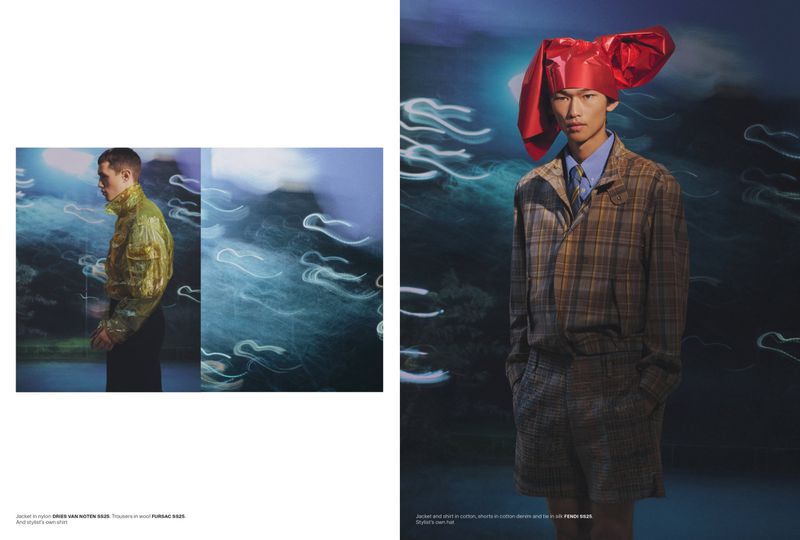 Editorial fashion shot featuring two Asian adult males modeling jackets and shirts in an abstract outdoor setting with blurred lighting.