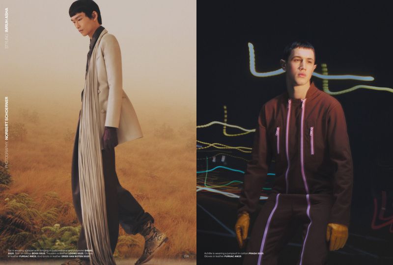 Two fashion models pose in studio. One is in earth tones in desert, the other is in a jumpsuit in front of a neon light display.