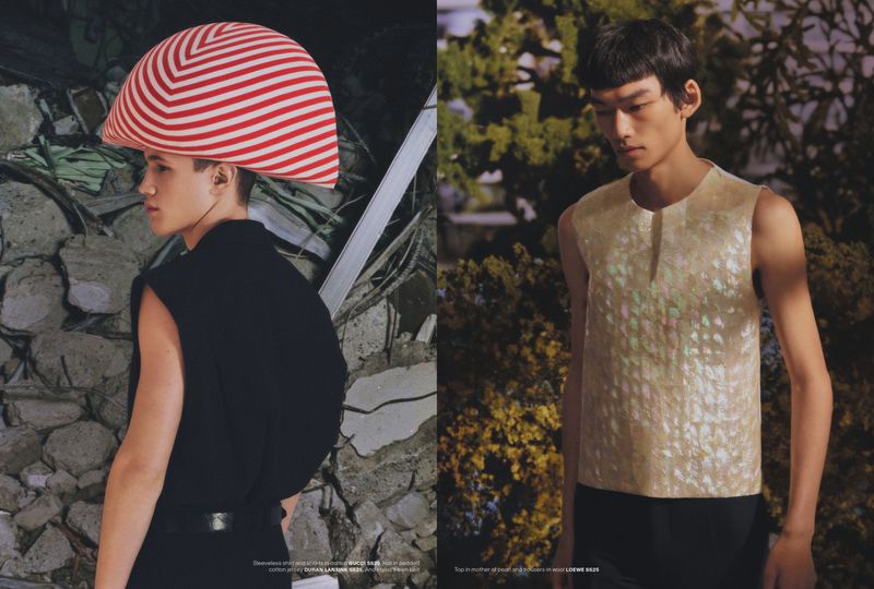 Two young men pose outdoors, one wearing a red and white striped hat, the other in a mother-of-pearl top, for a fashion editorial.