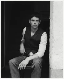 Black and white portrait of a man seated wearing a waistcoat and trousers