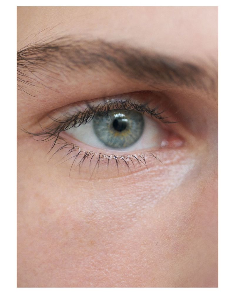 Extreme close up macro portrait of a blue eye with detailed skin texture and eyelashes for SSAW Magazine