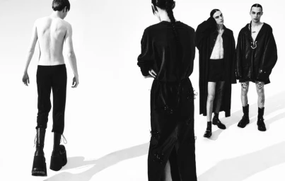 Monochrome fashion editorial image of four models posing against a bright white background for Boycott Magazine.