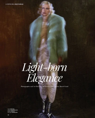 Fashion editorial shot of a person with fair skin, wearing a mint fur coat, dress and reflective boots, posing against a textured background.