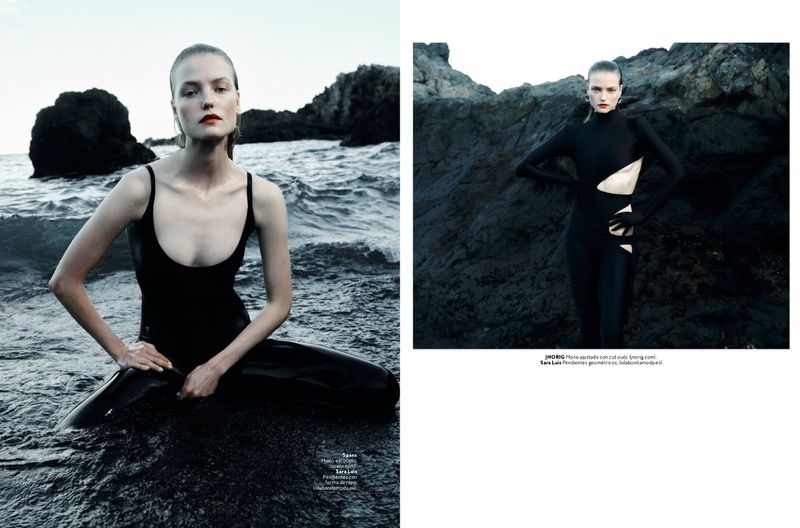 Fashion shoot featuring a model in a black swimsuit sitting on a black sand beach, and a second image of her in a black cutout catsuit.