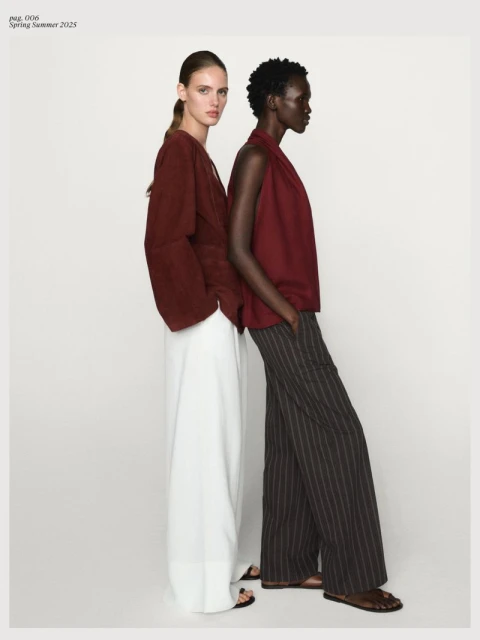 Two fashion models pose in stylish attire against a plain backdrop, showcasing contemporary designs and textures in soft, diffused light.