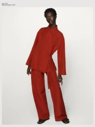 Model Amar Akway in a red wrap top and matching trousers against a plain white background for Massimo Dutti