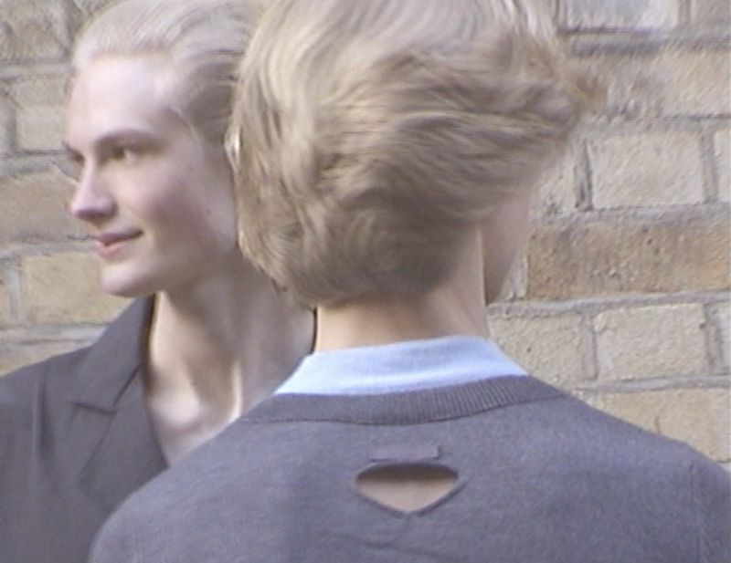 Two blond models with soft lighting against a textured brick wall background in a portrait for Fantastic Man.