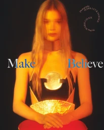 Portrait of a blonde woman wearing a black top with a metallic chest piece against a dark background, with text Make Believe