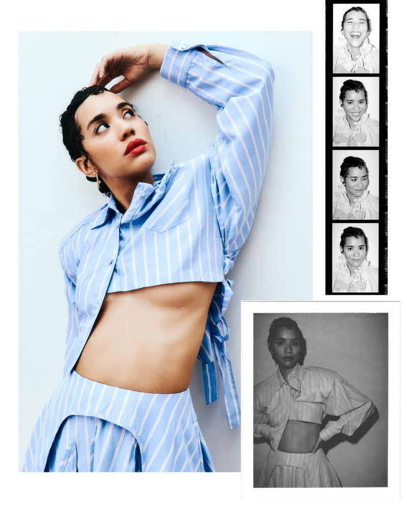 Woman in a blue and white striped crop top and skirt poses against a white wall, with photo booth strip and a print alongside her.