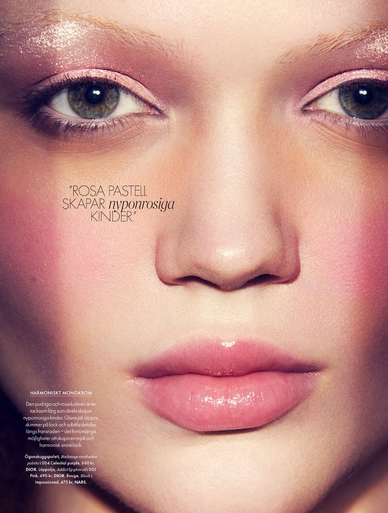Close-up portrait of a woman with pink makeup, light eyes, and fair skin. The lighting is soft, and text overlays part of the image.