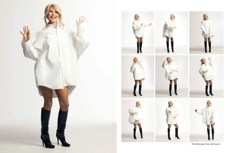 Smiling mature woman poses in an oversized white shirt and black knee-high boots against a white background in a fashion studio shoot.