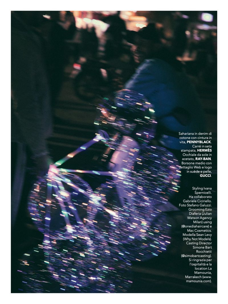 Close-up: fashion photo with illuminated spherical object in the foreground, people in the background, and stylized post-production.