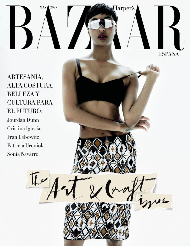 Fashion magazine cover featuring a model with sunglasses wearing a black bra top and patterned skirt against a bright white background.