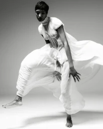 Model Jourdan Dunn leaping in a flowing white dress for Harper's Bazaar Espana by Javier Biosca