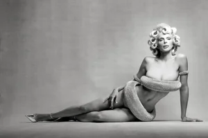Julia Fox posing in a monochrome fashion editorial for Tush Magazine, wearing metallic sculptural garments and curlers