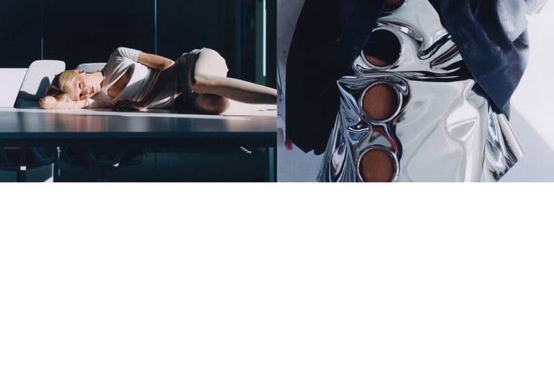 Fashion editorial shot of a blonde woman laying on a table alongside a silver metallic fashion garment with round cutout details.