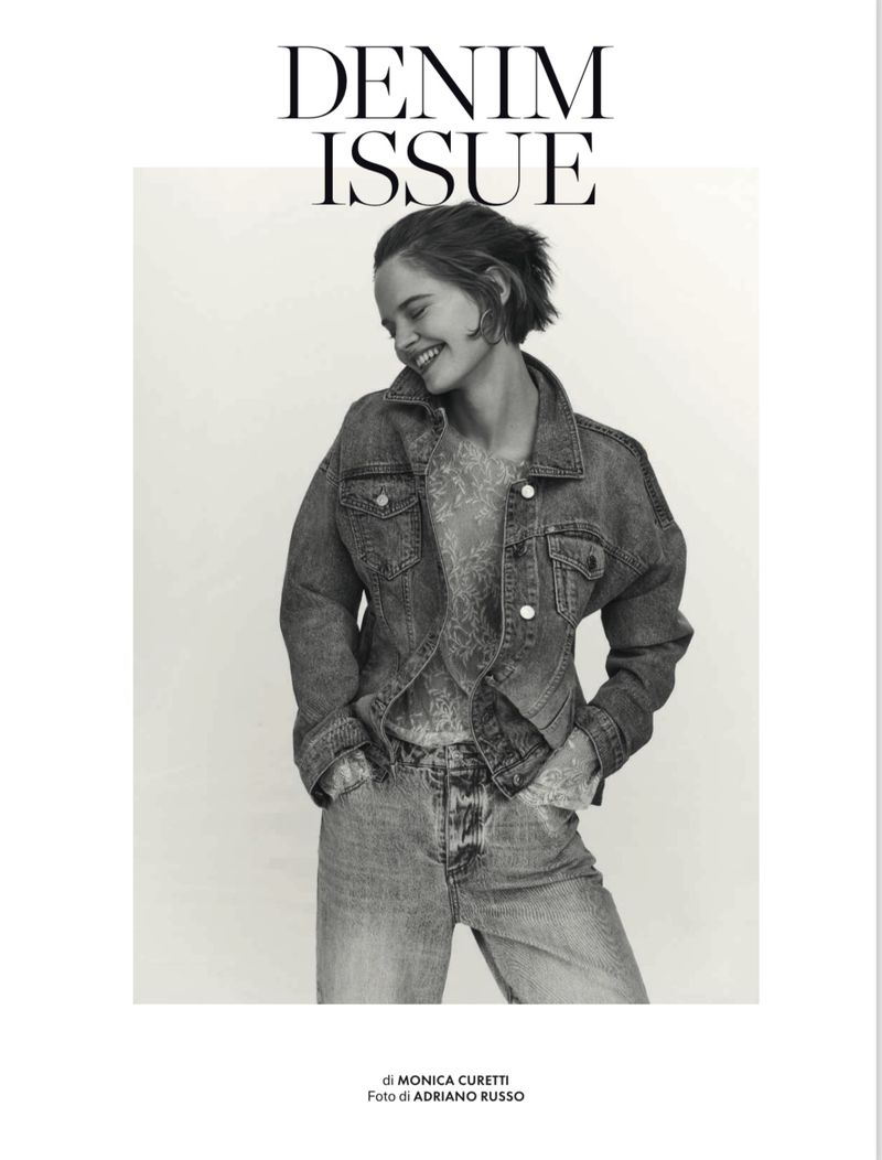 Smiling female model in denim jacket and jeans against a white background for Elle Italia Denim Issue