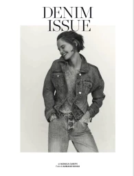 Smiling female model in denim jacket and jeans against a white background for Elle Italia Denim Issue