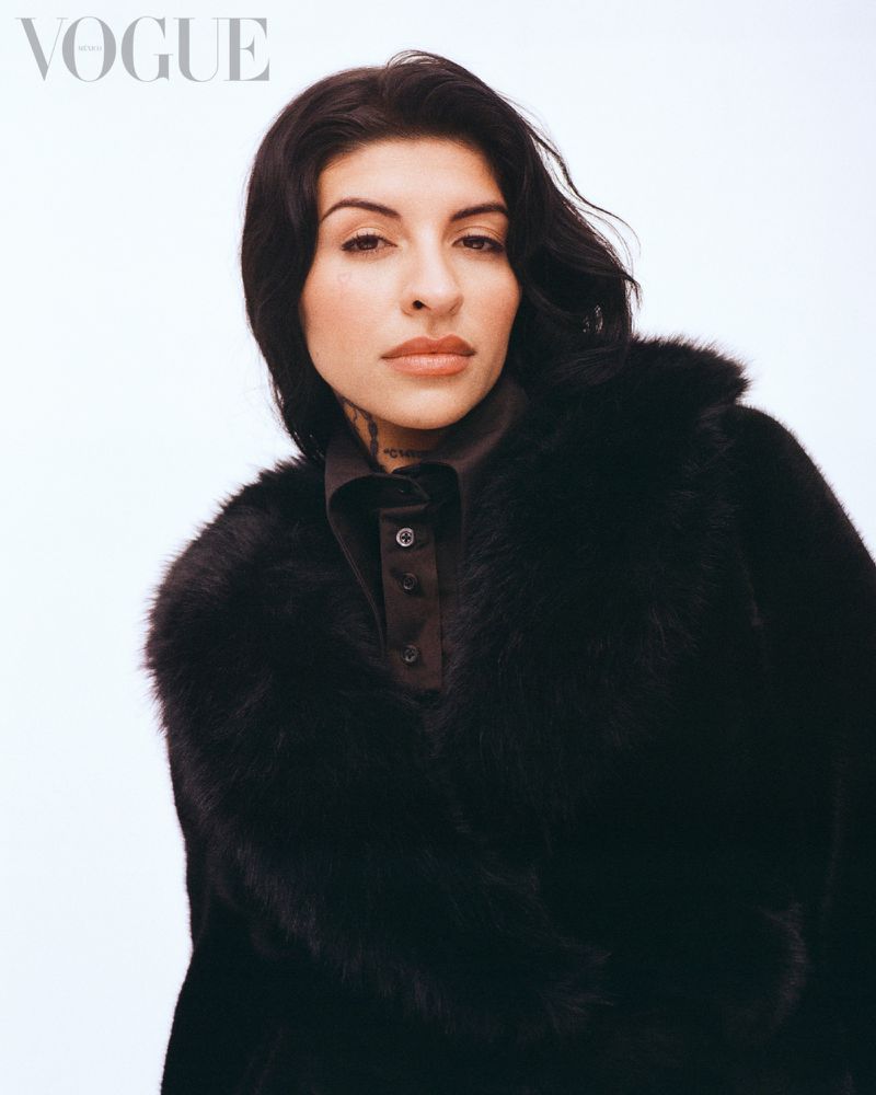 Portrait of a woman wearing a black faux fur coat against a white seamless background for Vogue Mexico