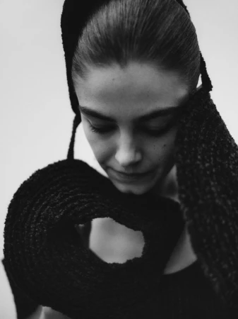 Close-up portrait of model Merlijne Schorren wearing dark textured knitwear photographed by Janne Rugland for Costume Denmark Merlinje project.