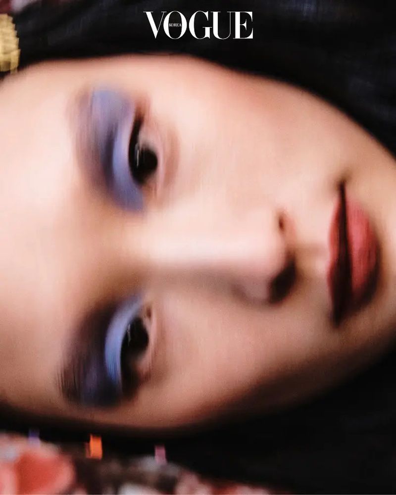 Close up beauty portrait of a model with blue eye shadow and dark lips for Vogue Korea editorial