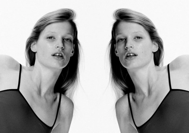 Monochrome portrait of a young fair-skinned woman with straight blonde hair, wearing a tank top, duplicated against a bright white backdrop.