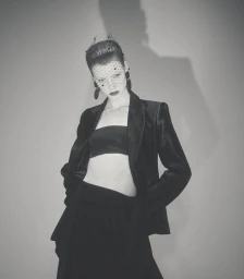 Model Dana Smith wearing a black velvet blazer and veil in High Voltage for D Repubblica, photographed by Casper Sejersen.